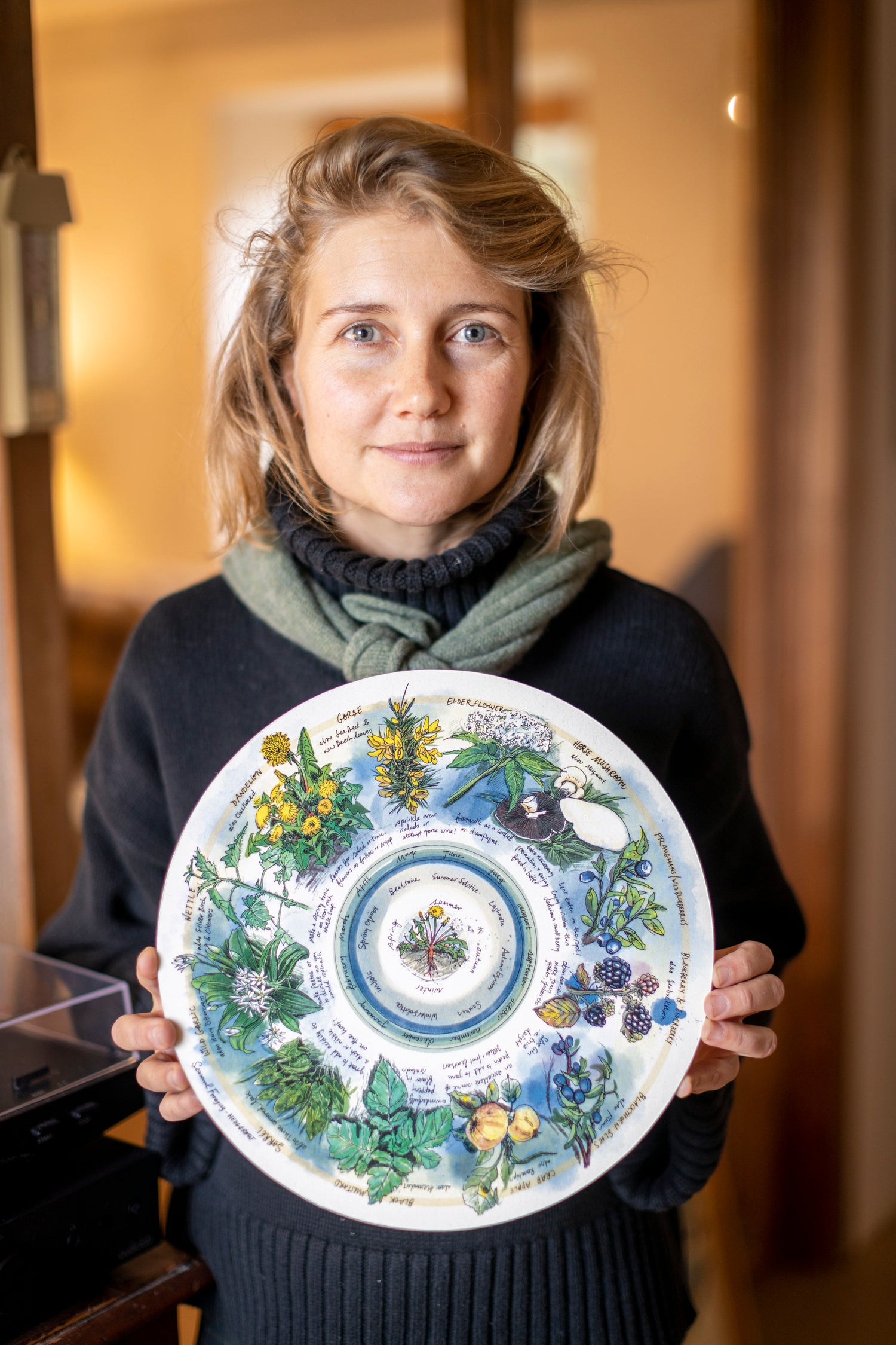 Emily Archer holding the Wheel of the Year.